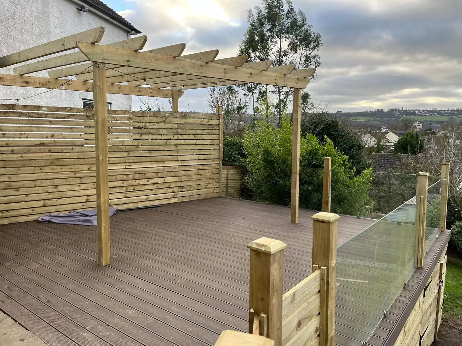 Composite deck with pergola and glass balustrade