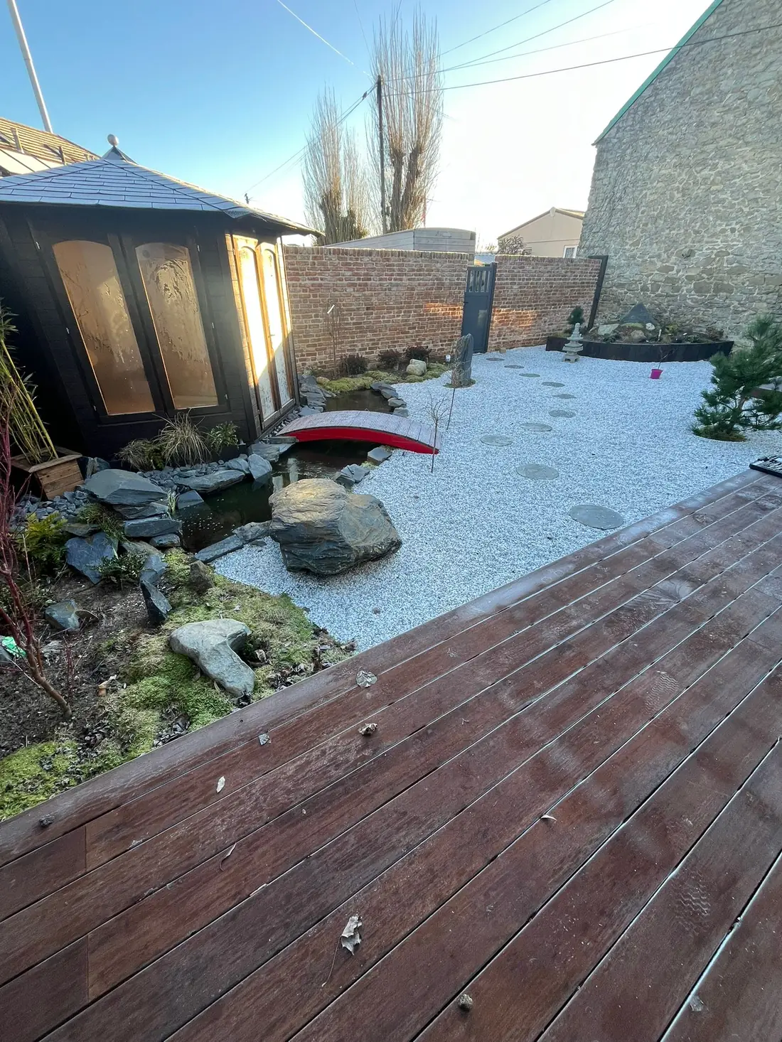 Japanese-inspired garden with summerhouse, decking and gravel