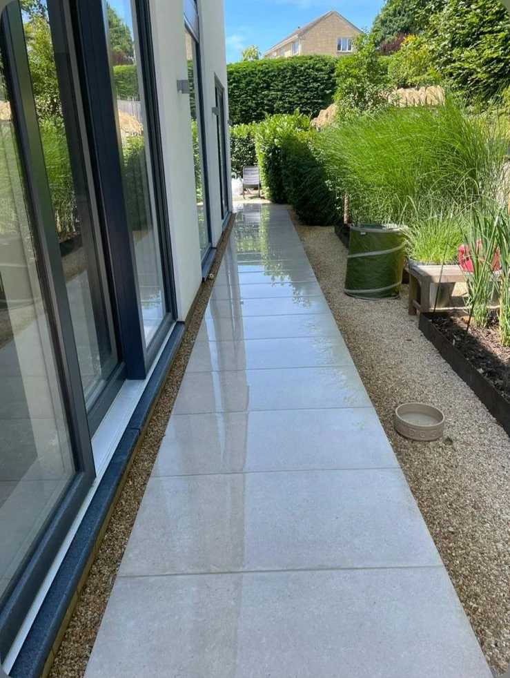 Porcelain pathway alongside modern house