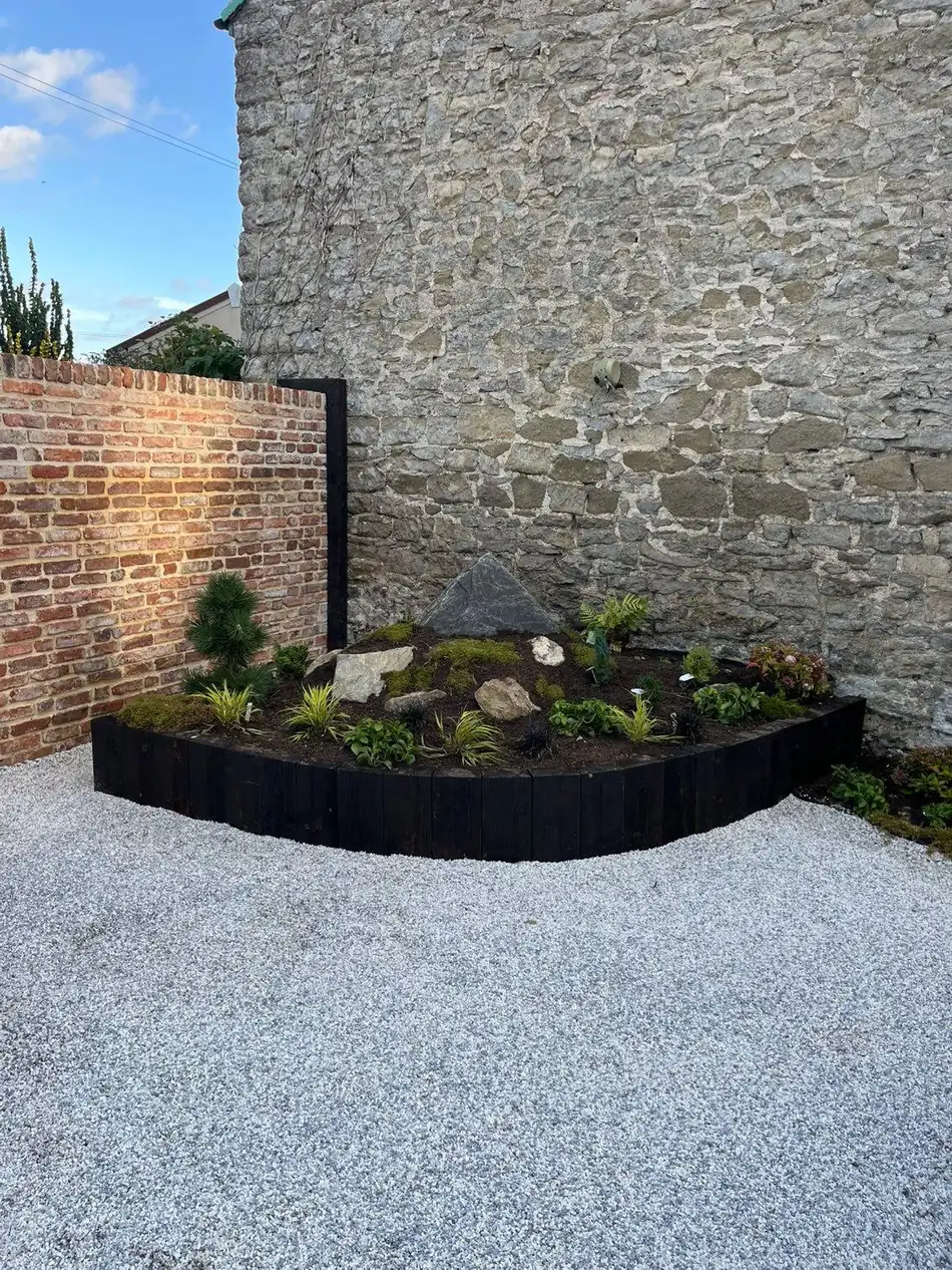 Raised planter bed against Bath stone wall